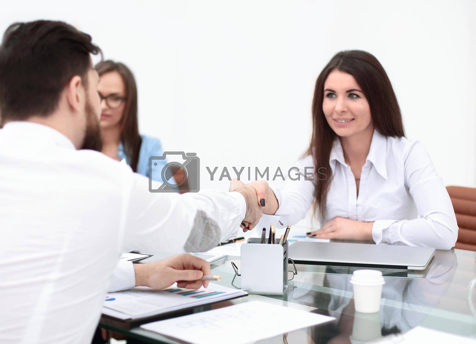 Royalty free image of business woman is shaking hands with an employee at a work meeting by SmartPhotoLab