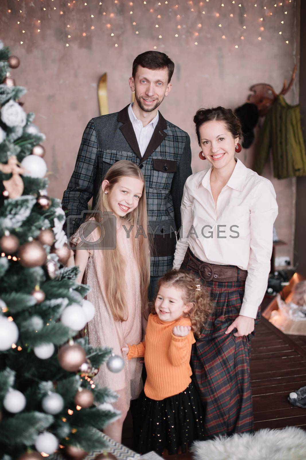 Royalty free image of family photo near the elegant Christmas tree by SmartPhotoLab