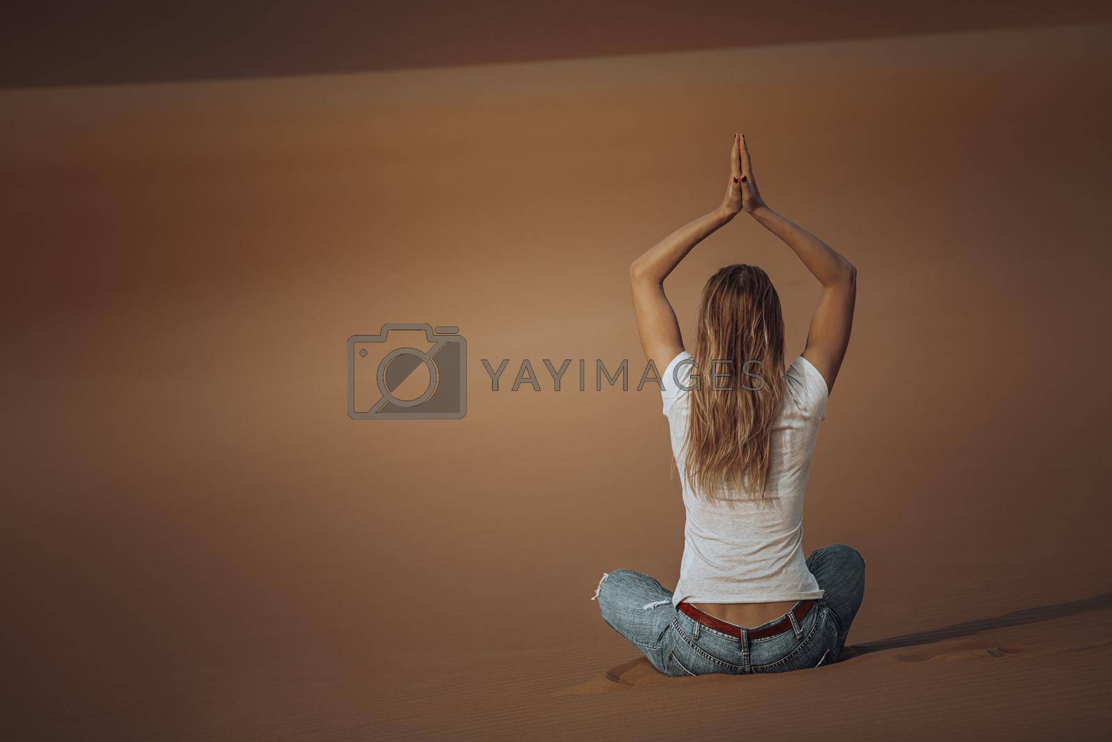 Nice Woman Doing Yoga Exercises in the Desert. Meditation Outdoors. Zen Balance and Harmony Concept.