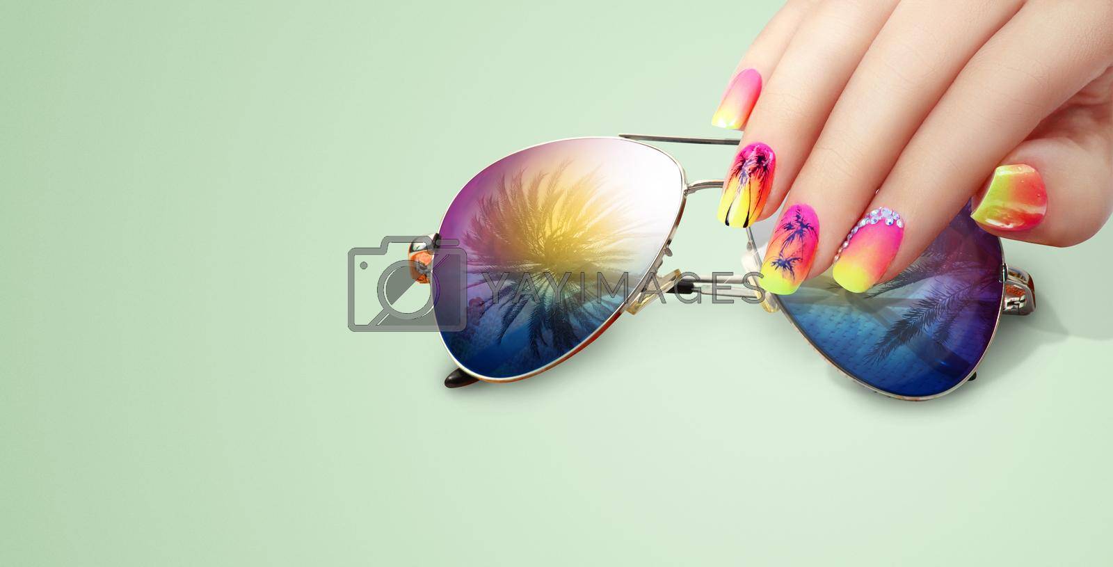 Royalty free image of Summer fashion and beauty hand care concept with sunglasses by Taut
