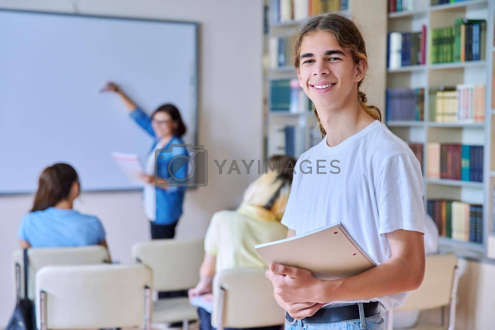 Royalty free image of Teenage guy in the classroom looking at the camera by VH-studio