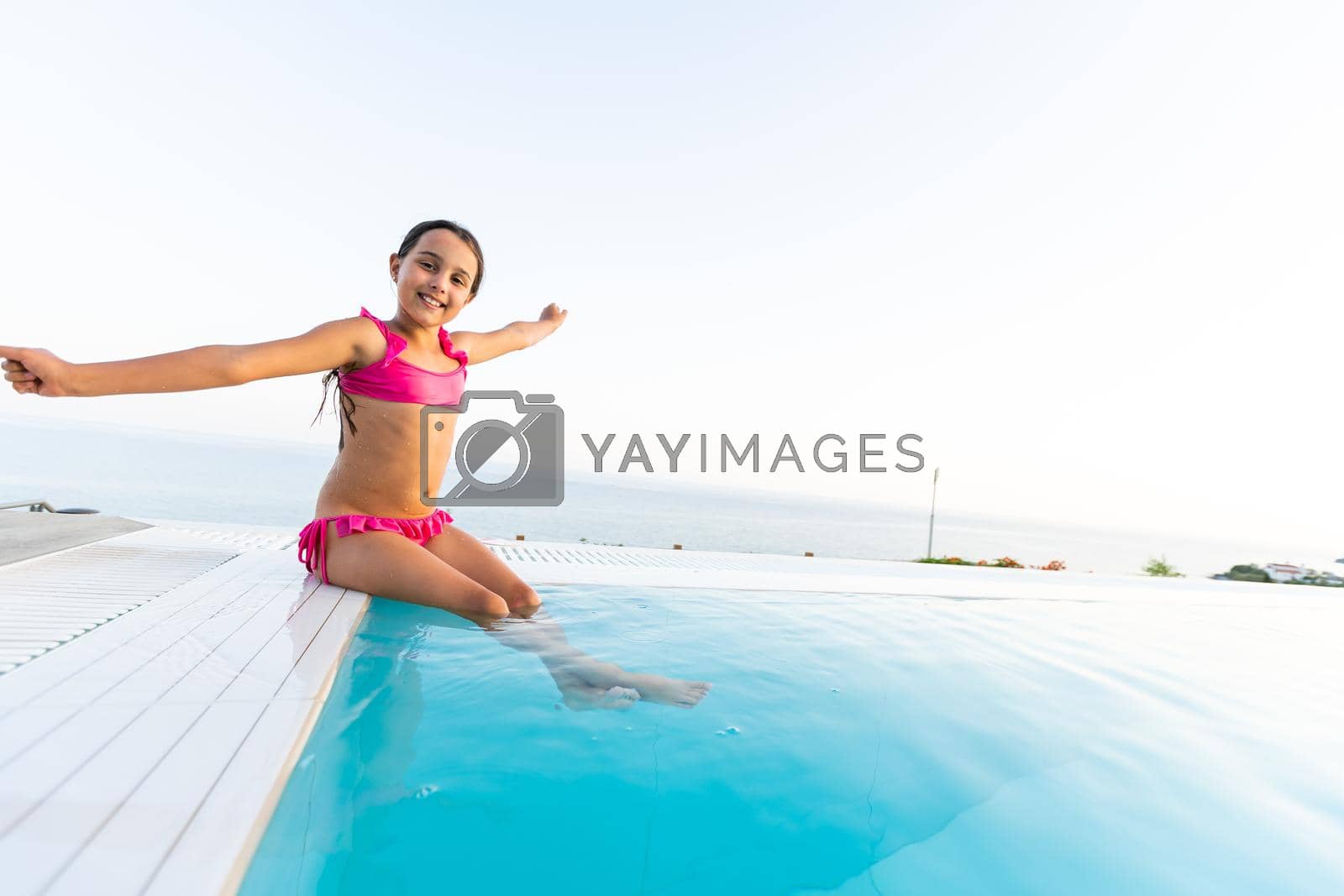 Royalty free image of Little girl in swimming pool. Summer outdoor. by Andelov13