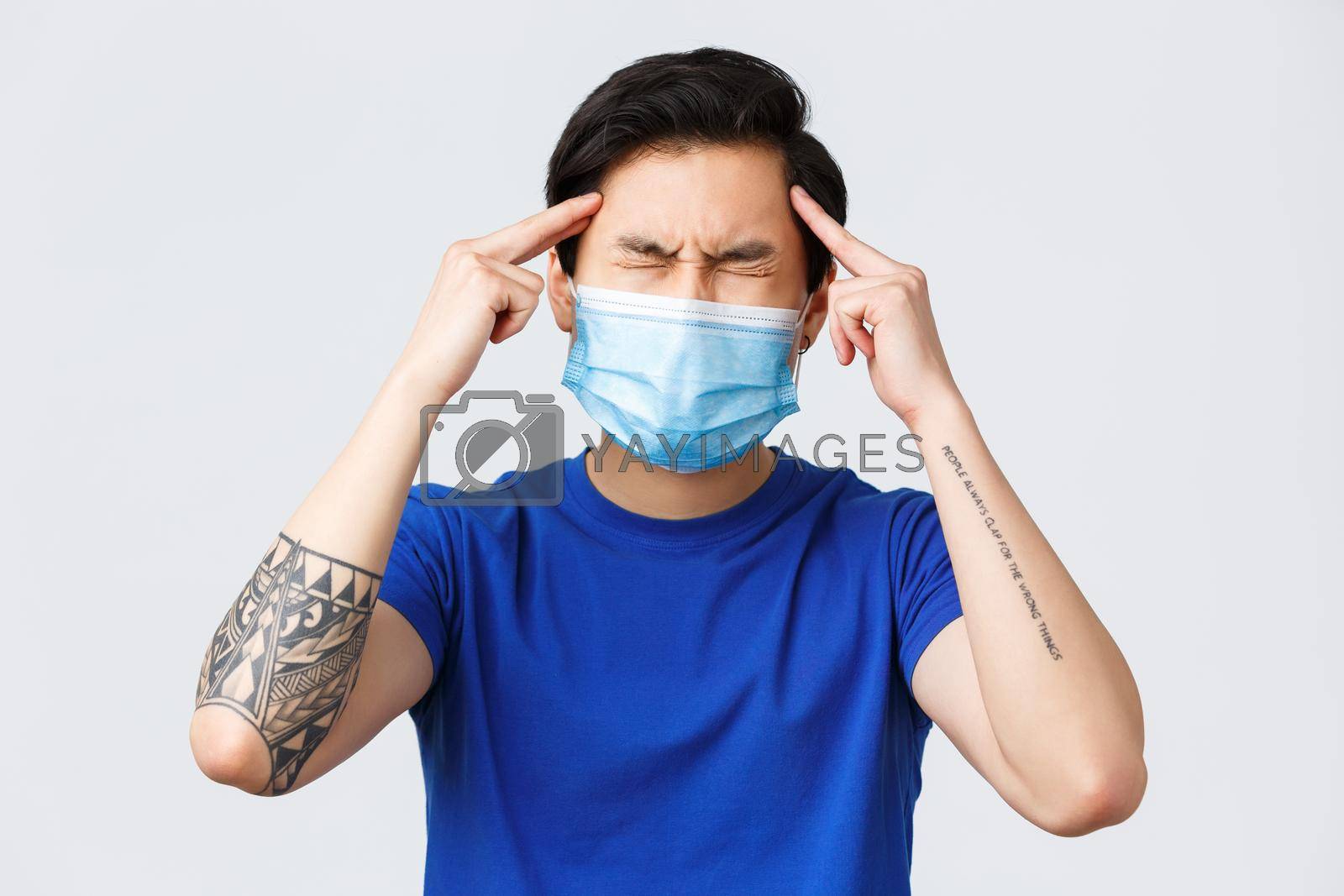 Royalty free image of Different emotions, lifestyle and leisure during coronavirus, covid-19 concept. Close-up of distressed and troubled young asian man cant think, touching temples and squinting, brainstorming by Benzoix