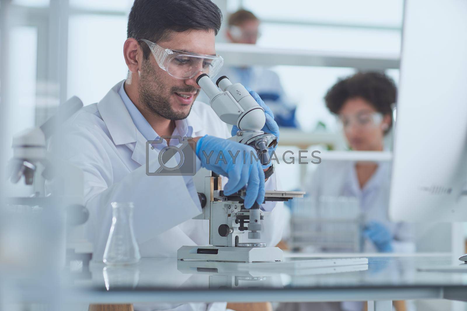 Royalty free image of Team of Medical Research Scientists Working on Generation Experimental Drug by asdf