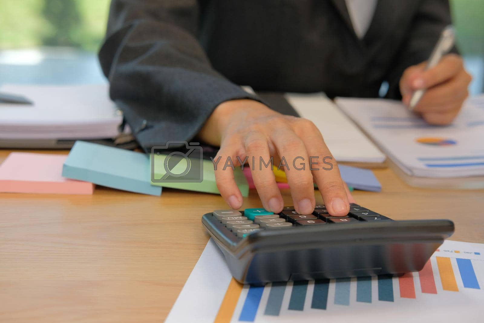 Royalty free image of financial adviser use calculator to calculate revenue & budget. accountant doing accounting. bookkeeper making calculation. by pp99