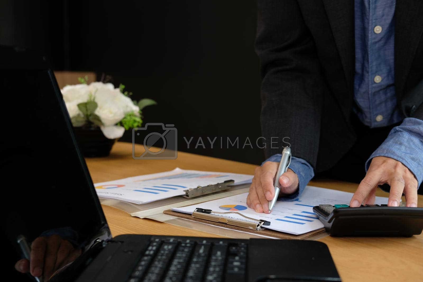 Royalty free image of financial adviser use calculator to calculate revenue & budget. accountant doing accounting. bookkeeper making calculation by pp99