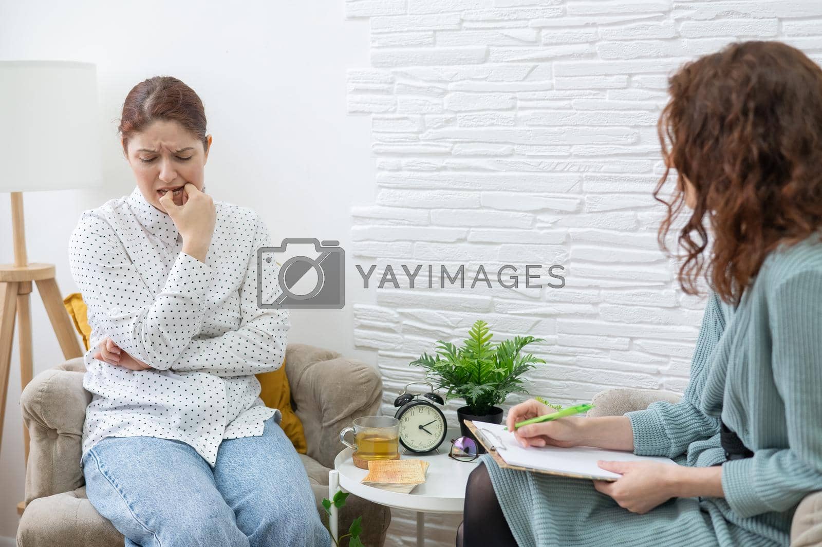 Royalty free image of Worried caucasian woman at a session with a psychotherapist. by mrwed54