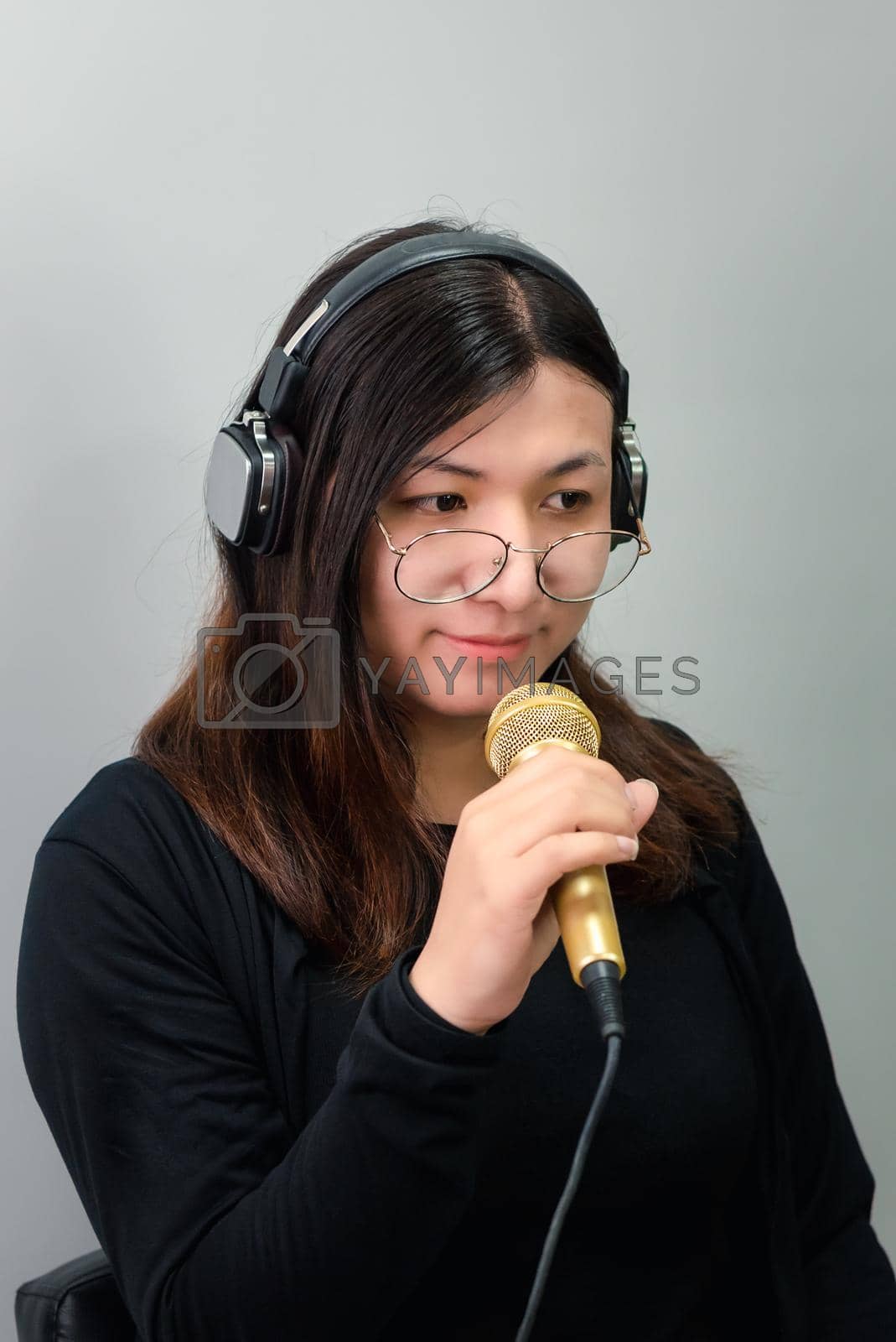 Royalty free image of Woman (LGBTQ) singer sing a song with microphone by NongEngEng