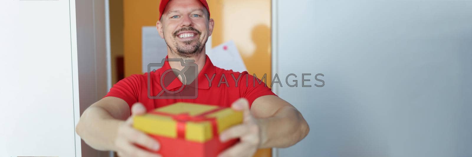 Royalty free image of Kind delivery man in uniform by kuprevich