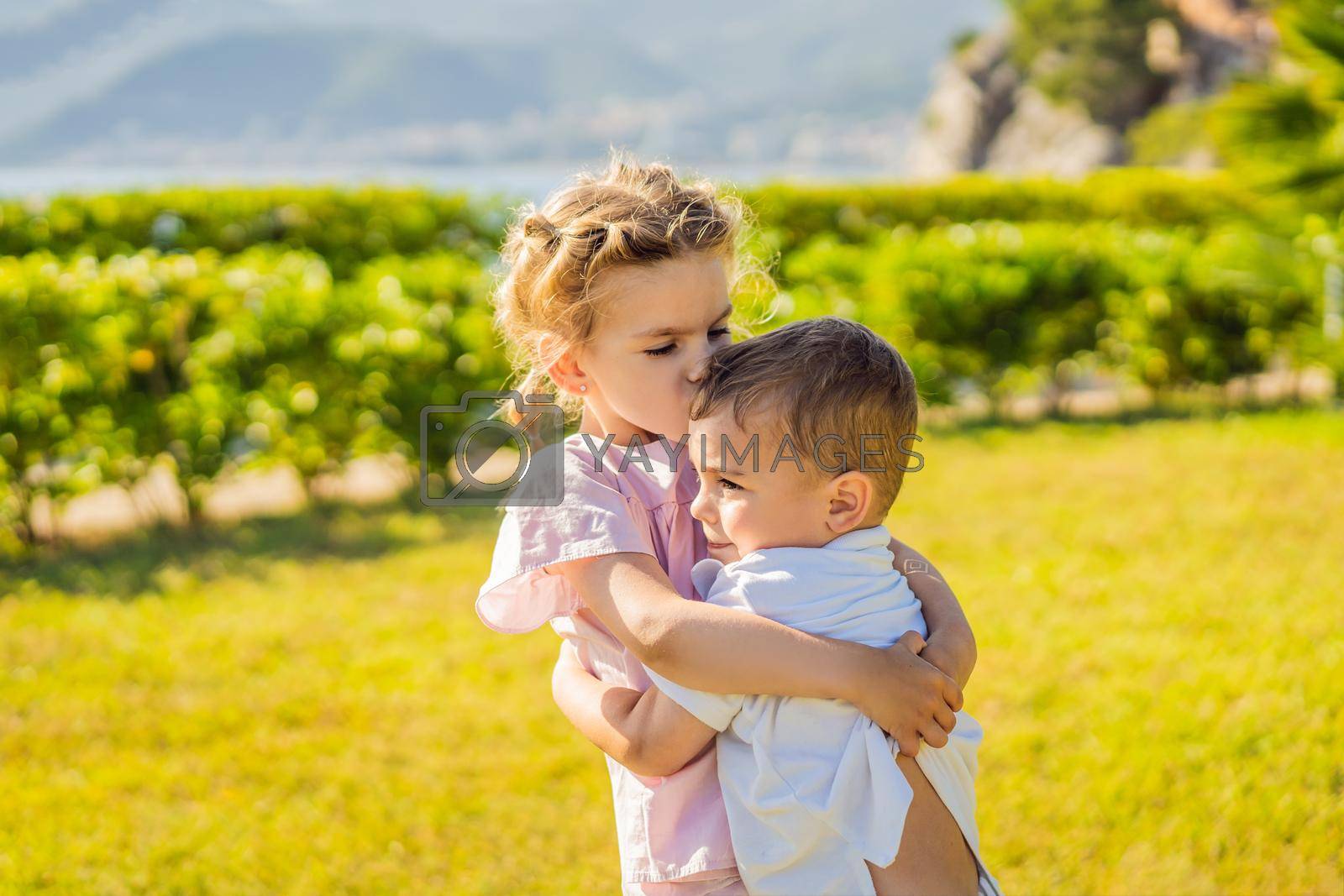 Royalty free image of Portrait of two cute adorable baby children toddlers hugging and kissing each other, love friendship in childhood concept, best friends forever by galitskaya