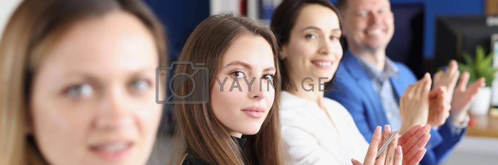 Royalty free image of Workers in presentable suits sit in room by kuprevich