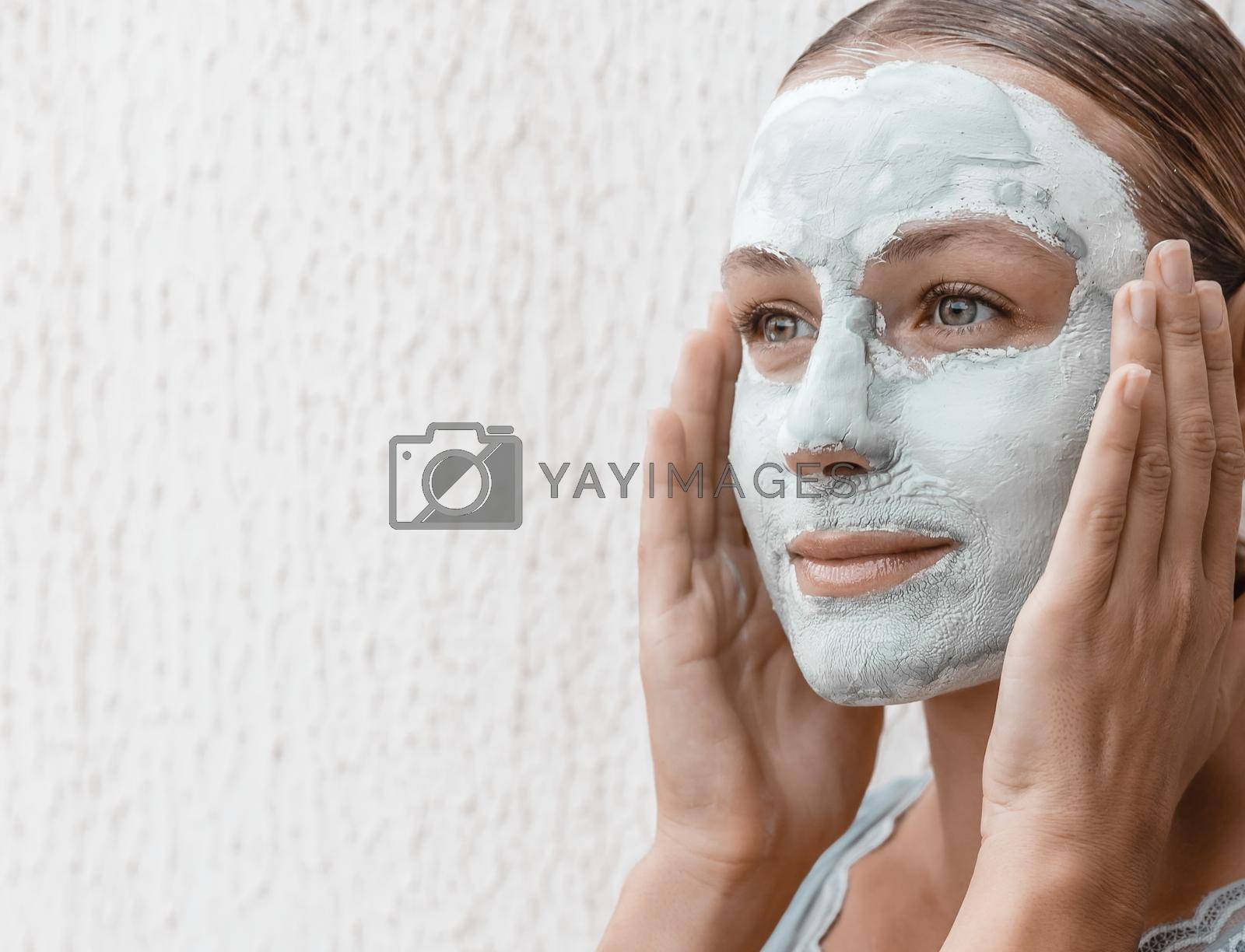 Portrait of a Nice Female Applying a Cream Mask in the Evening Before Sleep. Using Blue Clay for Perfect Skin. Health Care Concept.