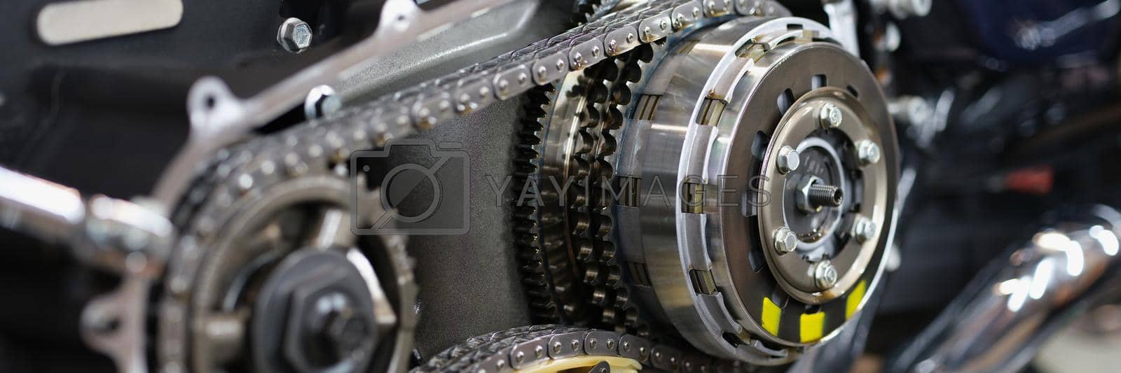 Royalty free image of Shiny detail of cool motorcycle rear chain with exhaust pipes by kuprevich
