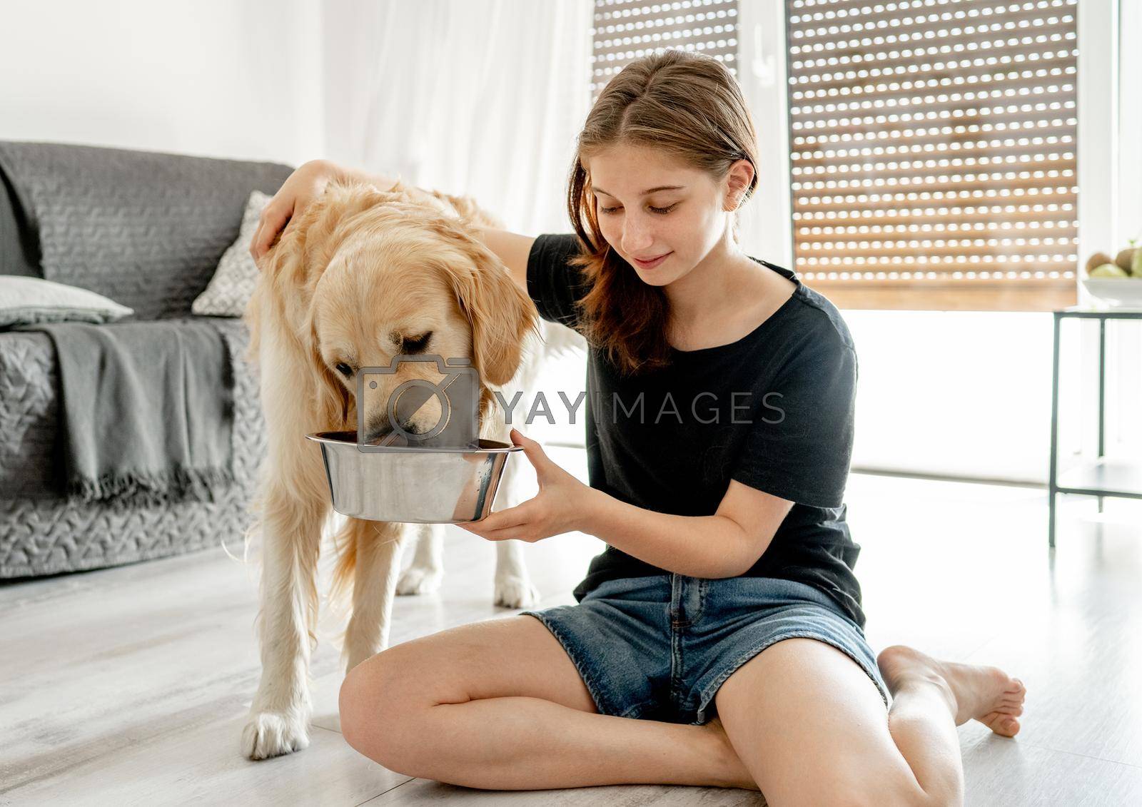 Royalty free image of Girl with golden retriever dog by tan4ikk1