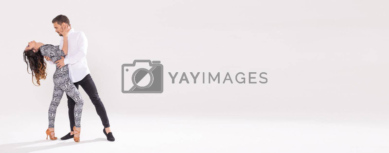 Royalty free image of Banner dancing social latin dance bachata merengue salsa. Two elegance pose on white background by Satura86