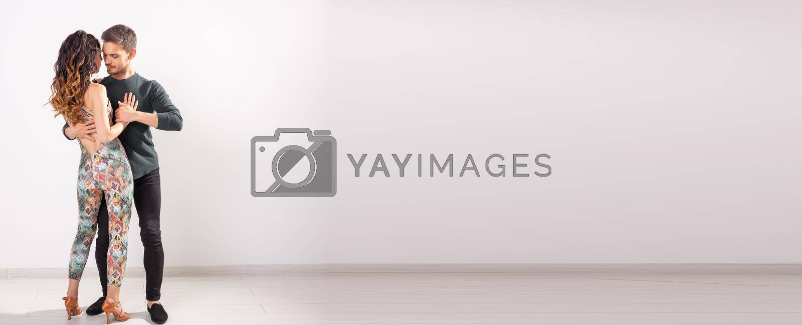 Royalty free image of Banner couple dancing social latin dance bachata, merengue, salsa. Two elegance pose on white background copy space by Satura86