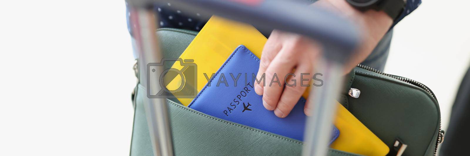 Royalty free image of Man taking out flight documents of bag by kuprevich