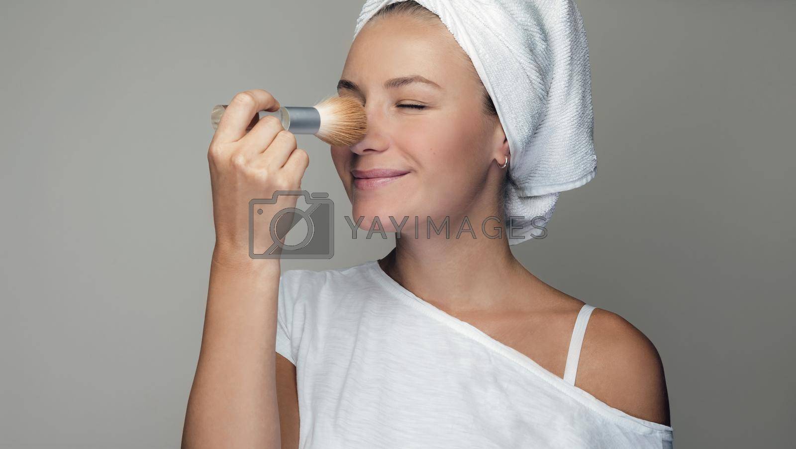 Royalty free image of Pretty Woman Applying Makeup by Anna_Omelchenko
