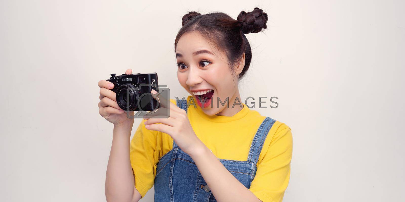 Royalty free image of Woman using photo camera in studio by makidotvn
