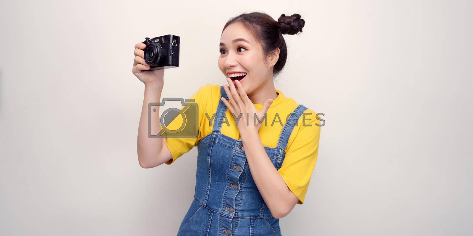 Royalty free image of Woman using photo camera in studio by makidotvn