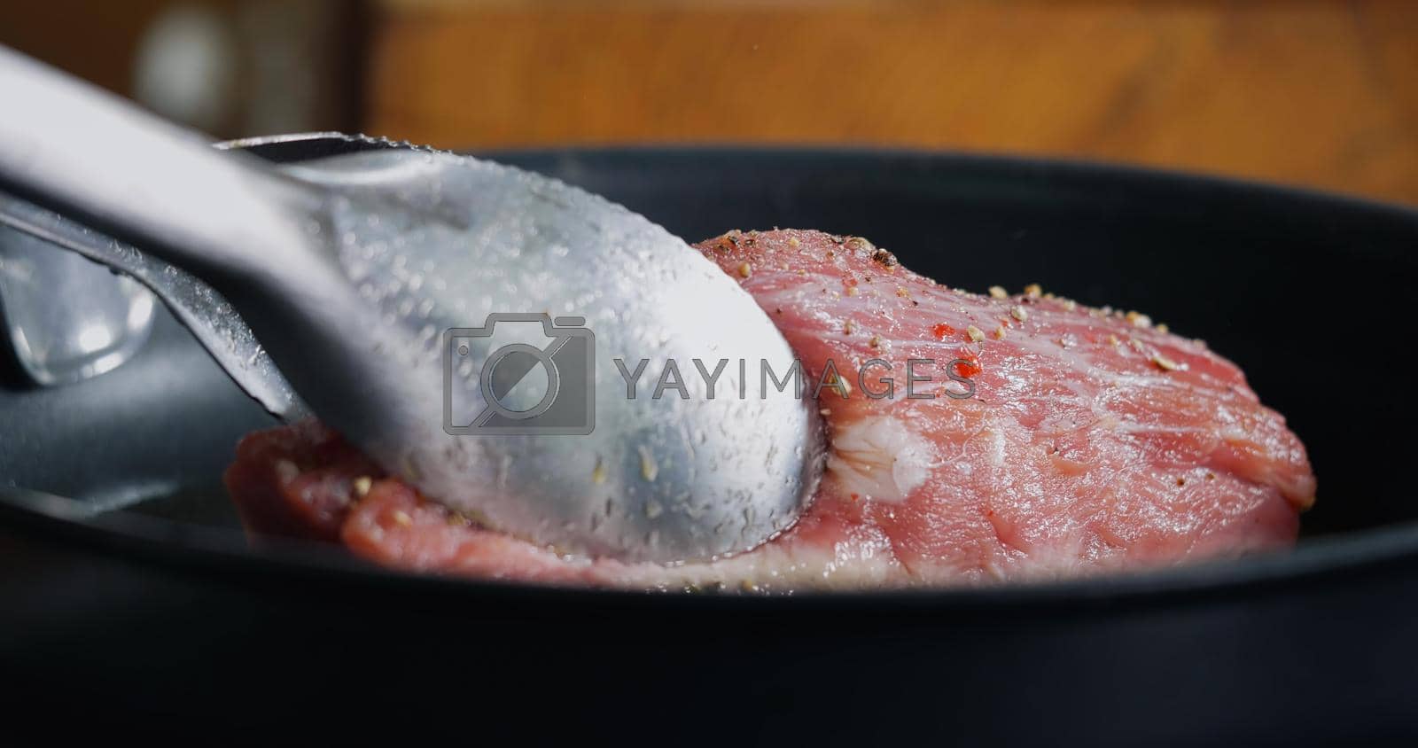 Royalty free image of Pork Meat Seasoned is Frying in Hot Pan. by RecCameraStock