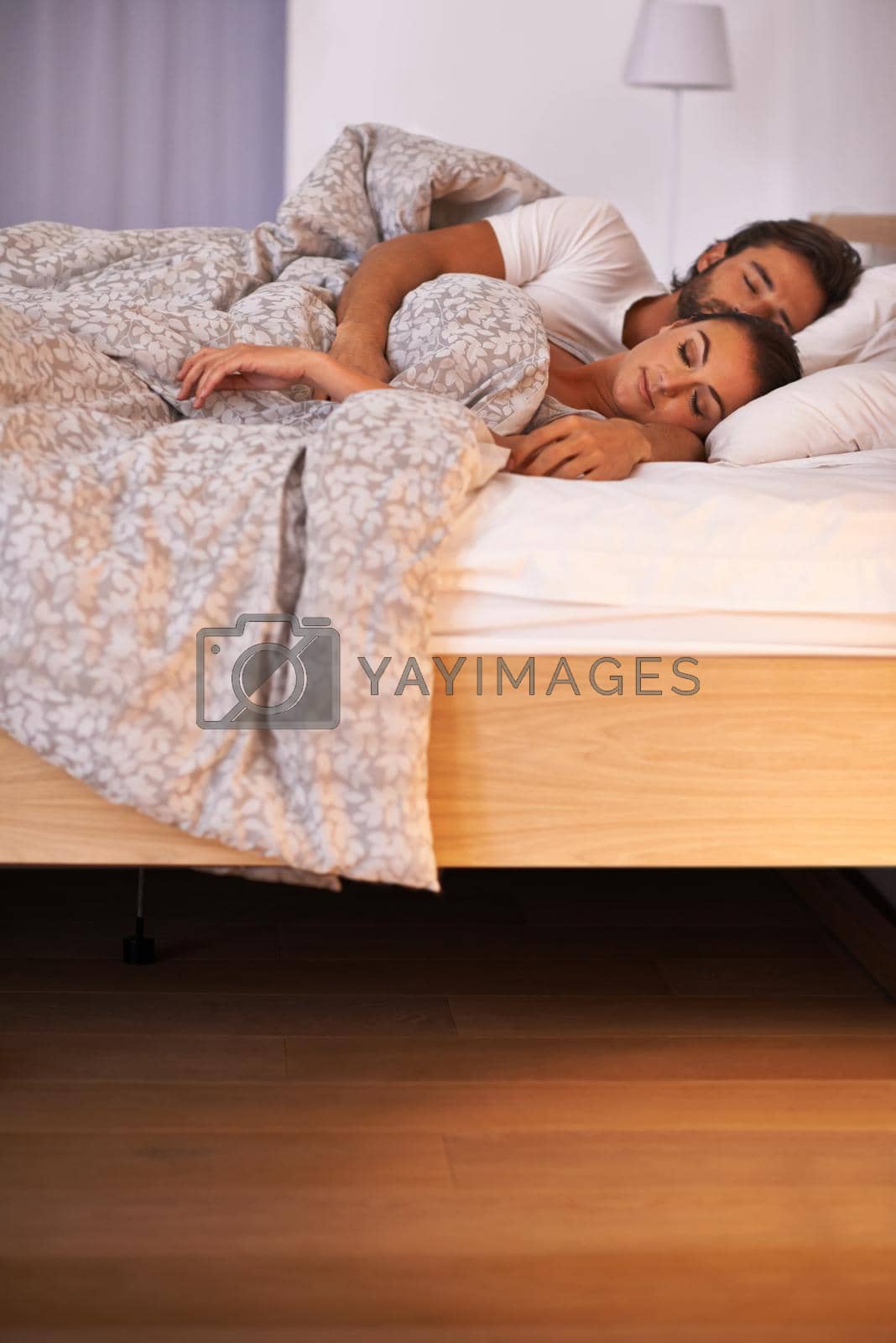 Royalty free image of Getting a peaceful night of rest. A couple sleeping in their bed. by YuriArcurs