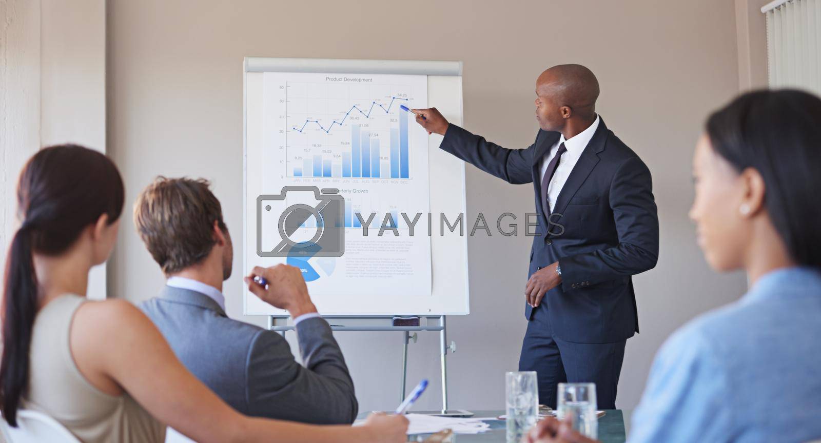 Shot of a business manager presenting financial data to his colleagues during a meeting.