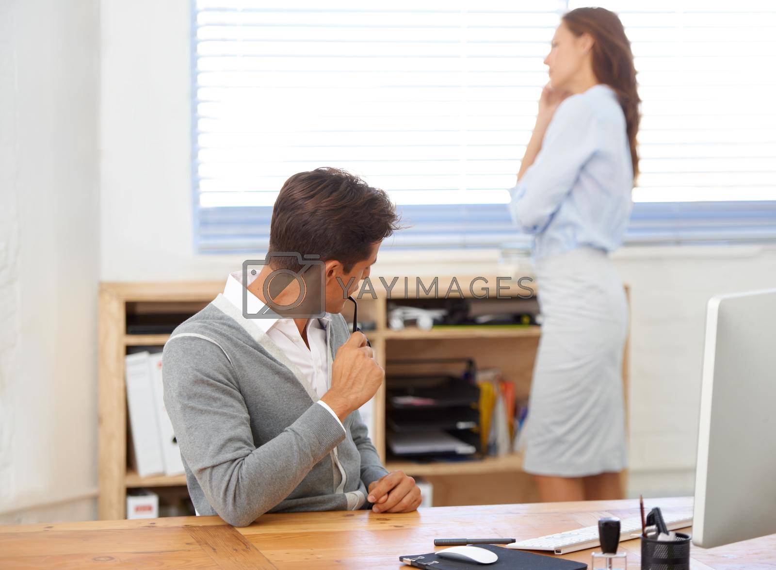 Royalty free image of Improper office etiquette. A businessman checking out his female colleague. by YuriArcurs