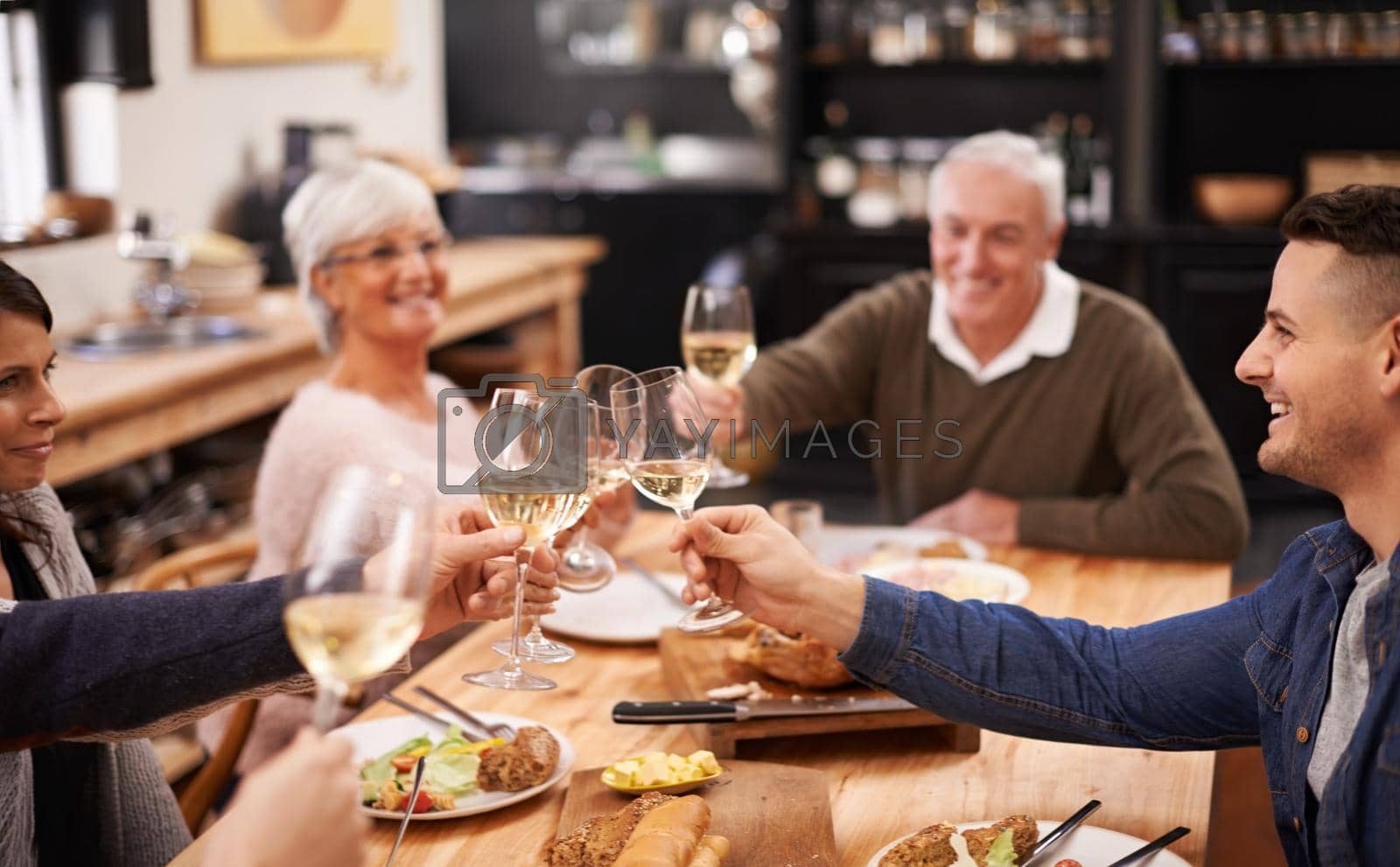 Royalty free image of Friends and family are the true gifts in life. Shot of a family sitting down to dinner. by YuriArcurs