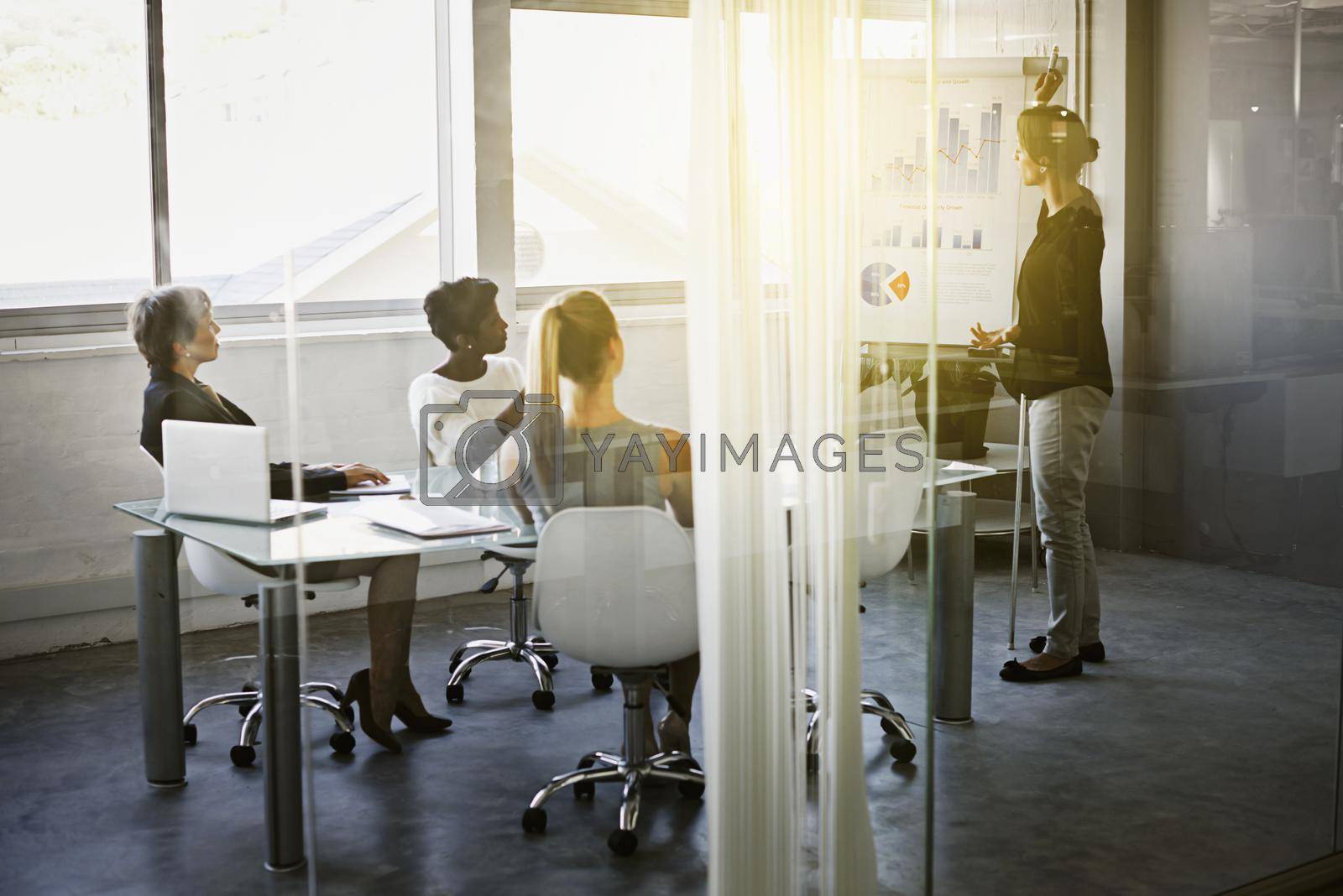 Royalty free image of So if you look at the numbers from last quarter.... Shot of a businesswoman giving a presentation in the boardroom. by YuriArcurs