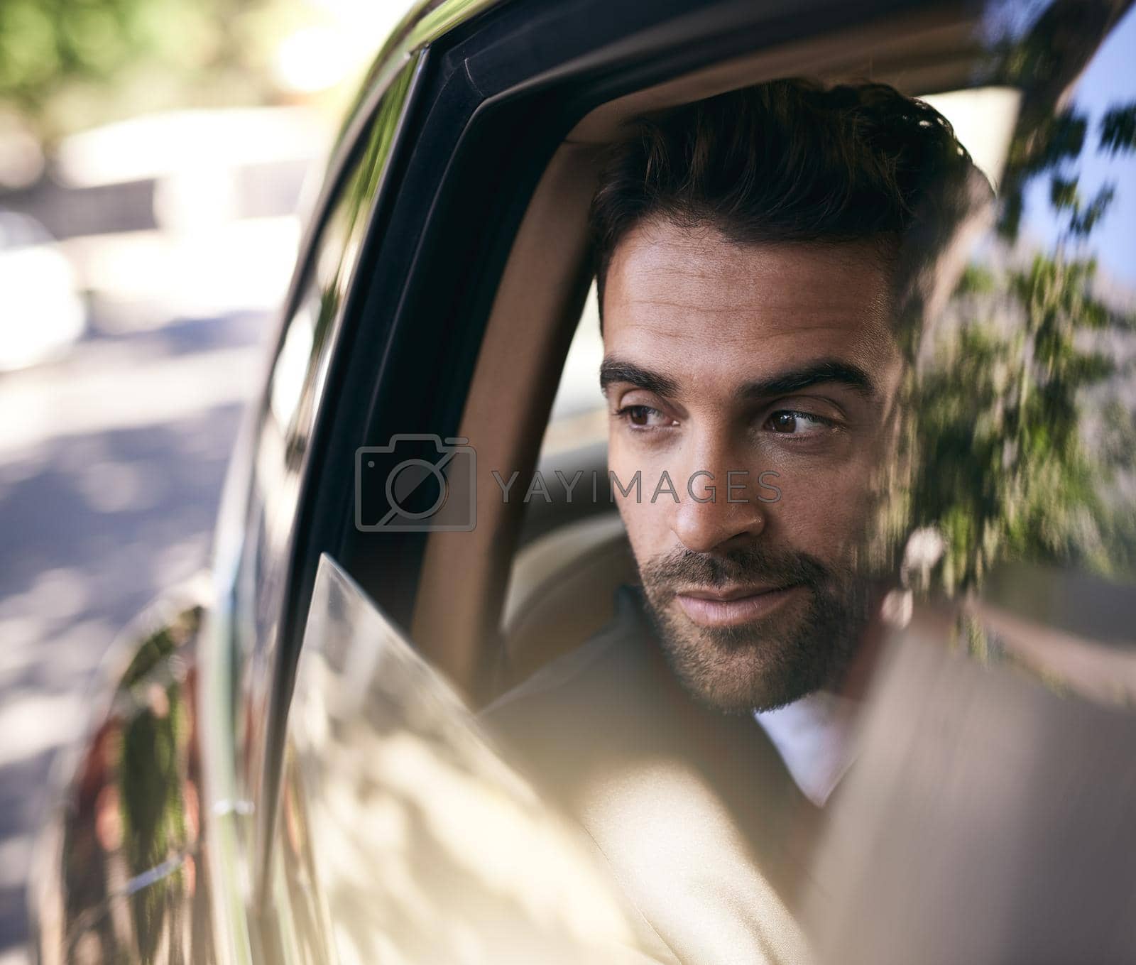 Royalty free image of Pulling up to the office in style. Cropped shot of a handsome young businessman on his morning commute to work. by YuriArcurs