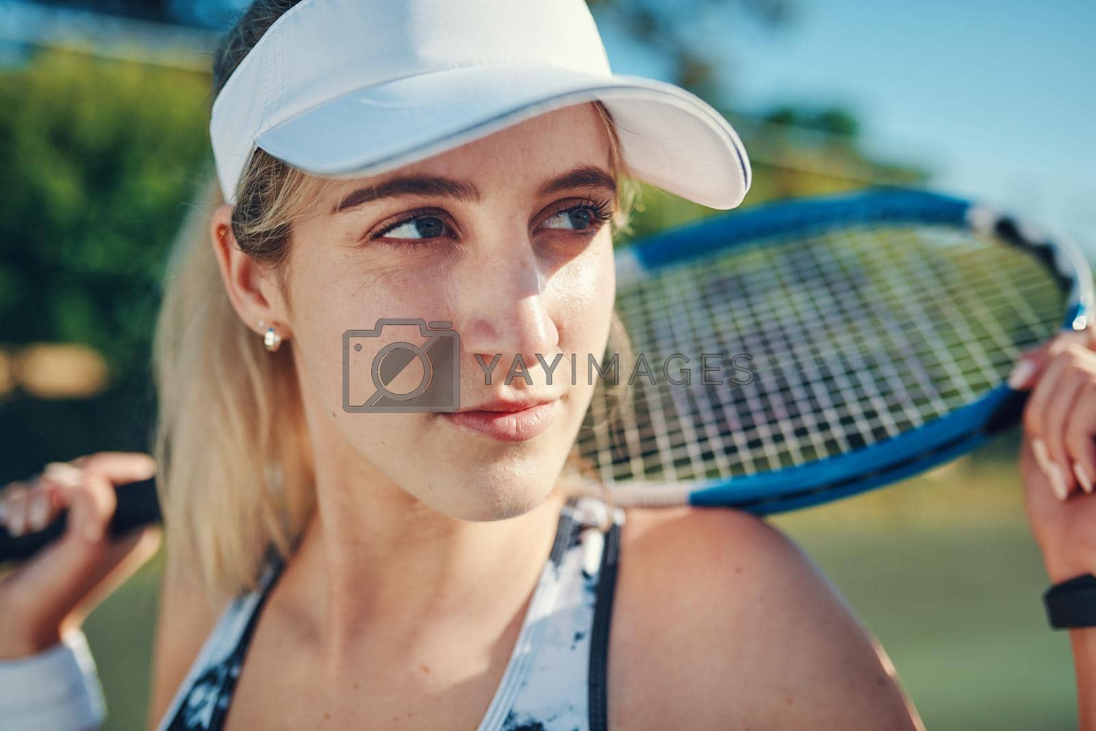 Royalty free image of Nobody who ever gave it their best regretted it. Shot of a sporty young woman standing on a tennis court with a tennis racket. by YuriArcurs