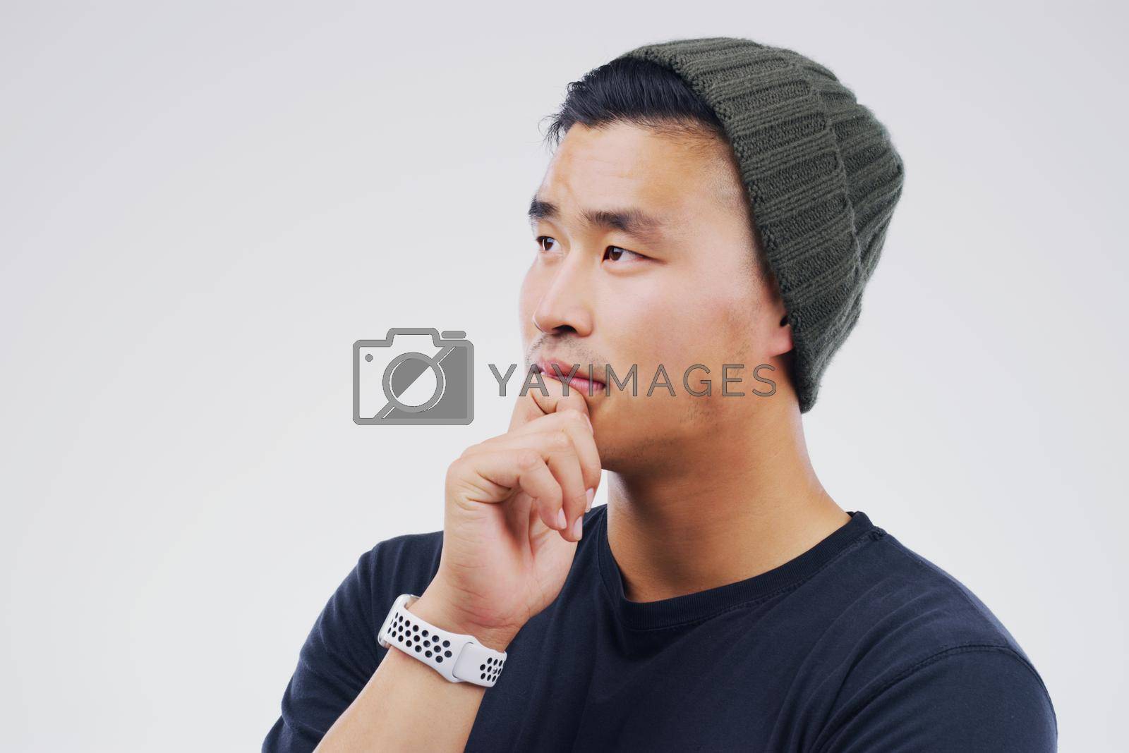Royalty free image of Im thinking more clearly now. Studio shot of a man looking thoughtful against a gray background. by YuriArcurs
