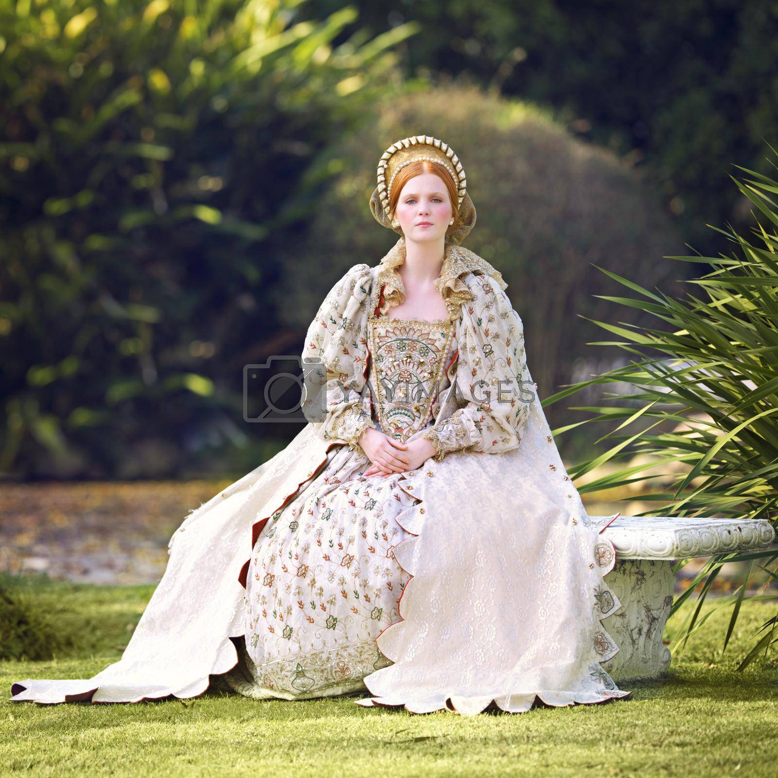 Royalty free image of Awaiting her king. Portrait of a noble woman sitting outdoors on palace grounds. by YuriArcurs