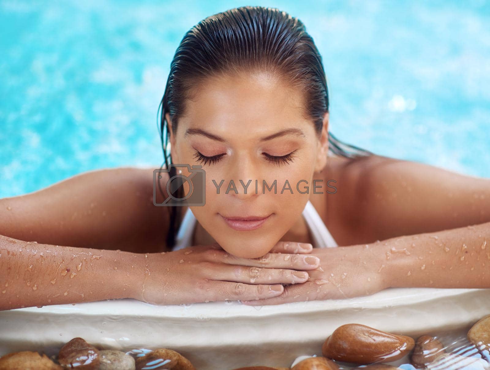 Royalty free image of Remember to pamper yourself. Shot of a young woman relaxing at a spa pool. by YuriArcurs