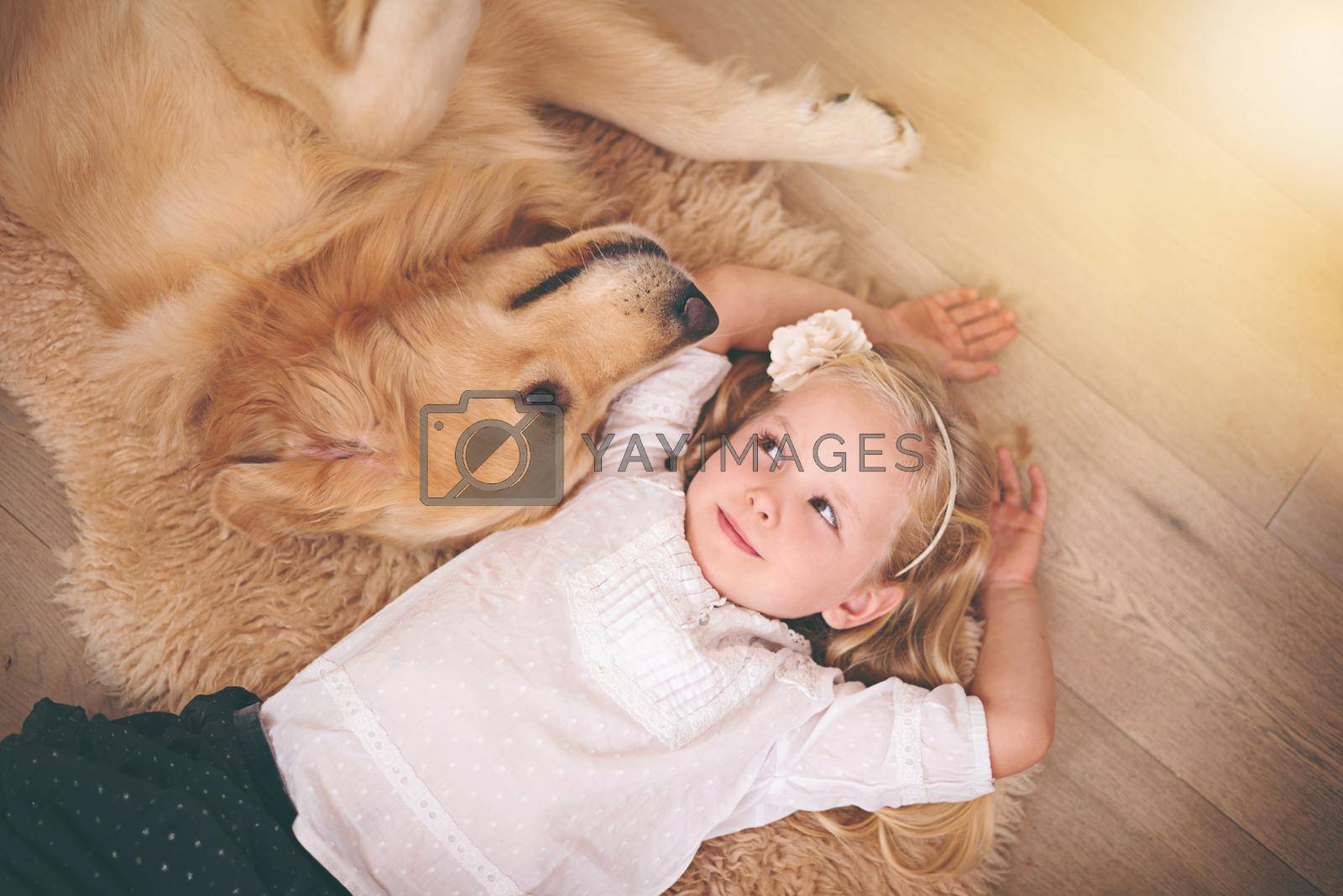 An adorable little girl with her dog at home.