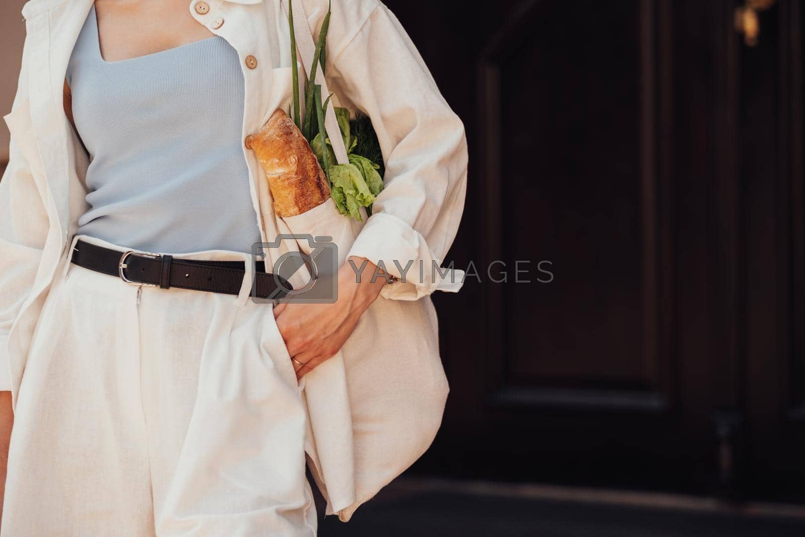 Royalty free image of Unrecognisable Stylish Woman Holding Shopping Eco Bag with Groceries Outdoors, Copy Space by Romvy