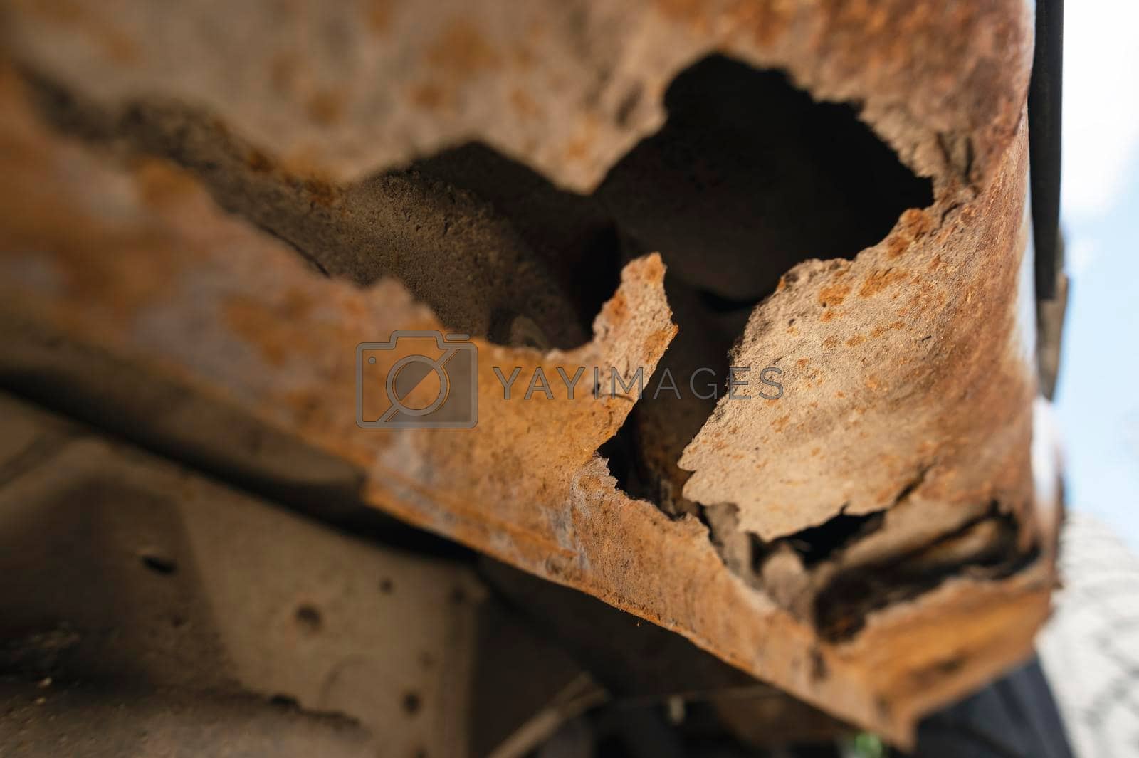 Royalty free image of Rusty car body damaged by corrosion with hole on threshold by yanik88