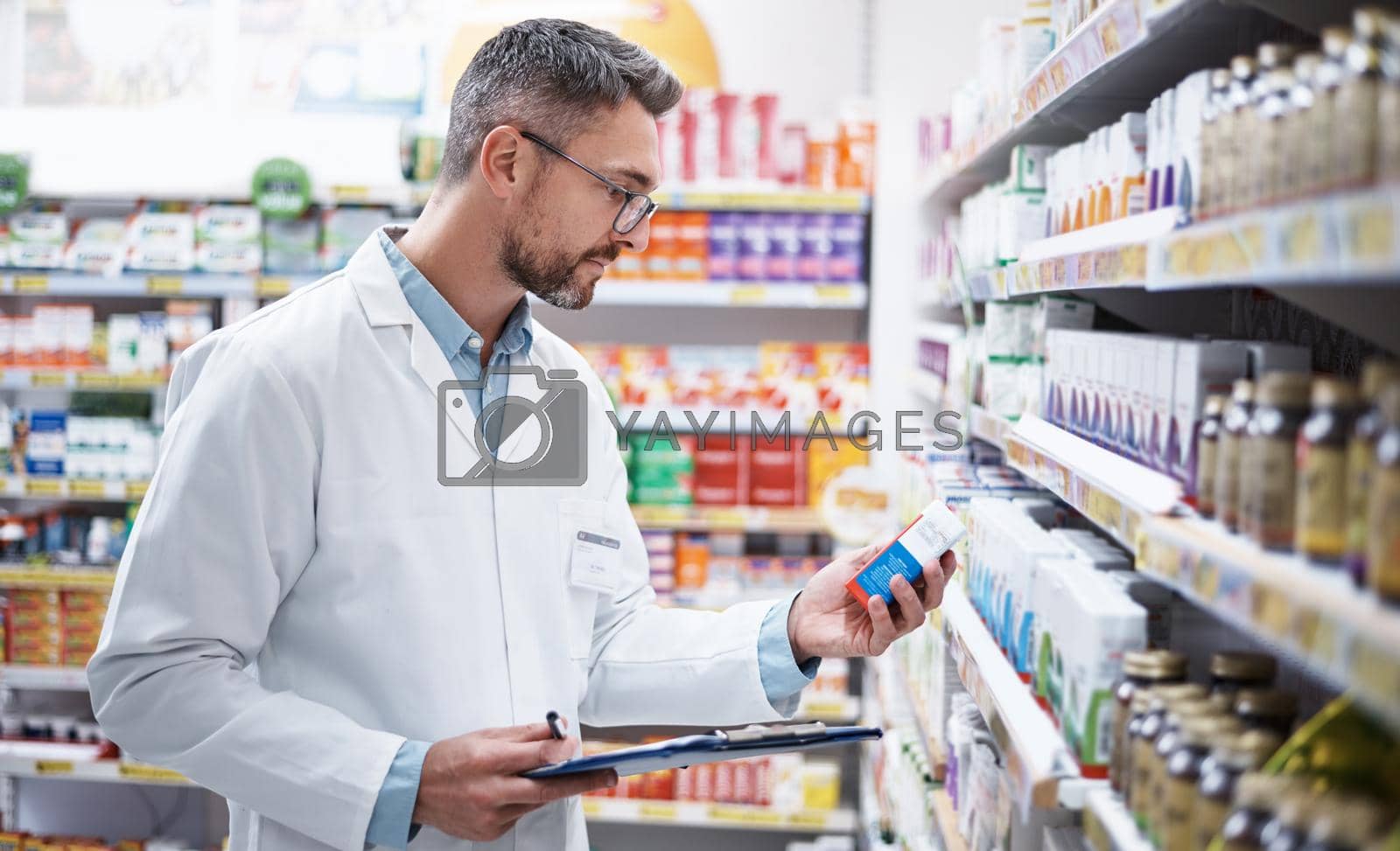 Royalty free image of Stocking the shelves is top priority. Shot of a mature pharmacist doing inventory in a pharmacy. by YuriArcurs