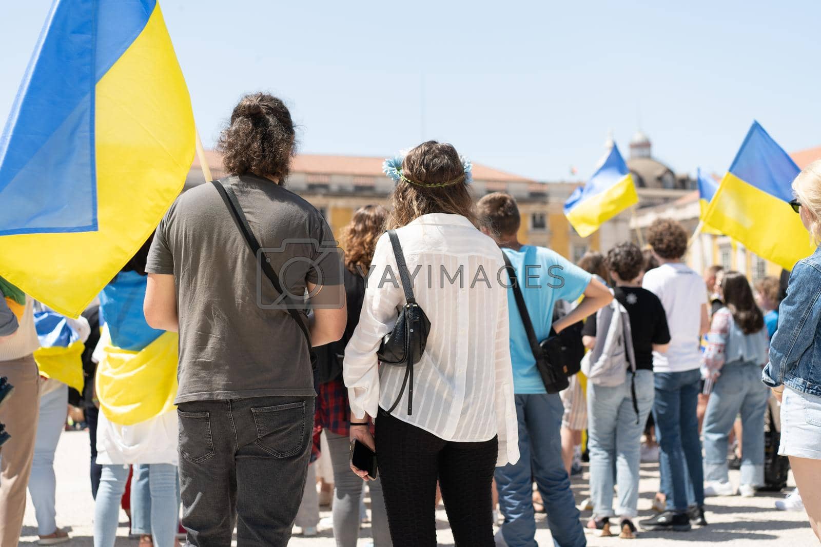 Royalty free image of Portugal, Lisbon April 2022: The demonstration on Commerce Square in support of Ukraine and against the Russian aggression. Protesters against Russia's war Many people with Ukrainian flags. by andreonegin