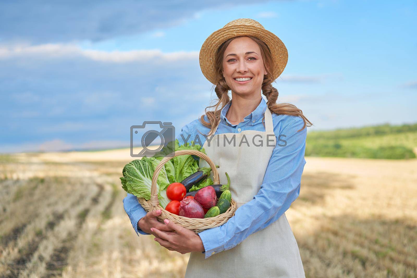 Royalty free image of Woman farmer straw hat apron standing farmland smiling Female agronomist specialist farming agribusiness Happy positive caucasian worker agricultural field by andreonegin