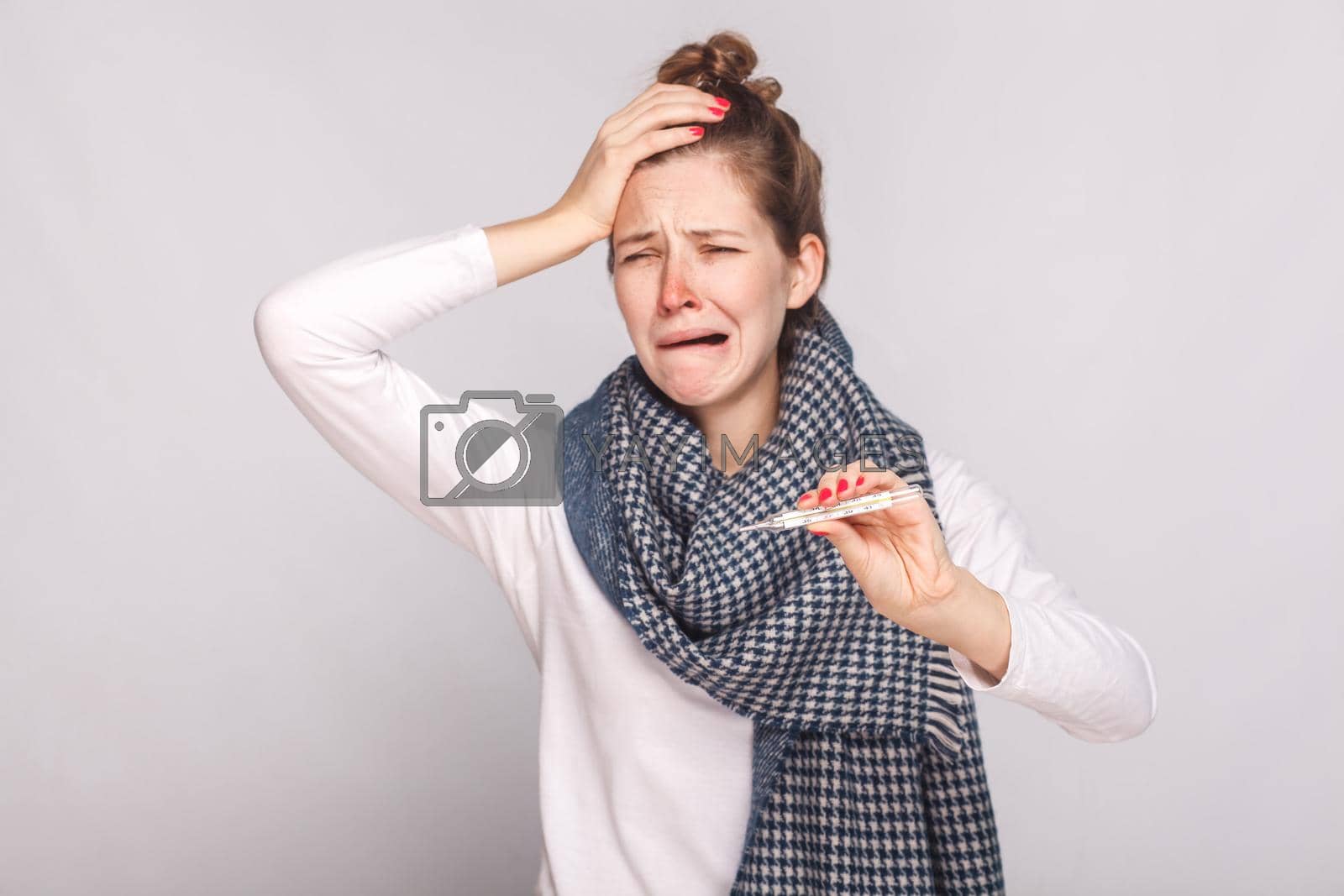 Royalty free image of Unwell sick woman have temperature, holding head and cry. by Khosro1