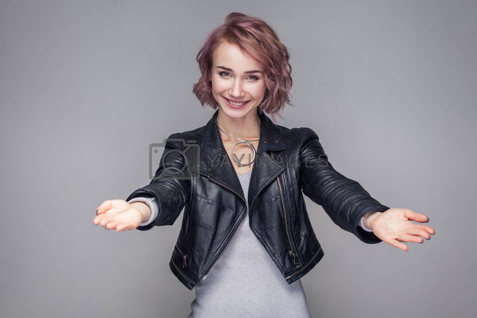 Royalty free image of Emotional hipster girl with jacket on gray background by Khosro1