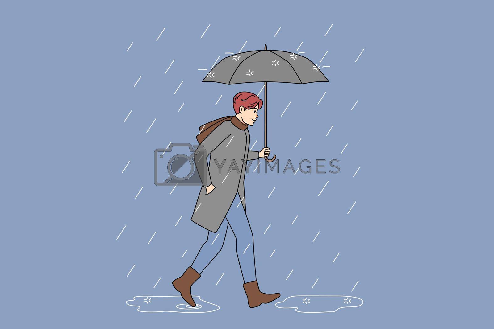 Royalty free image of Man with umbrella walking in rain by Vasilyeu