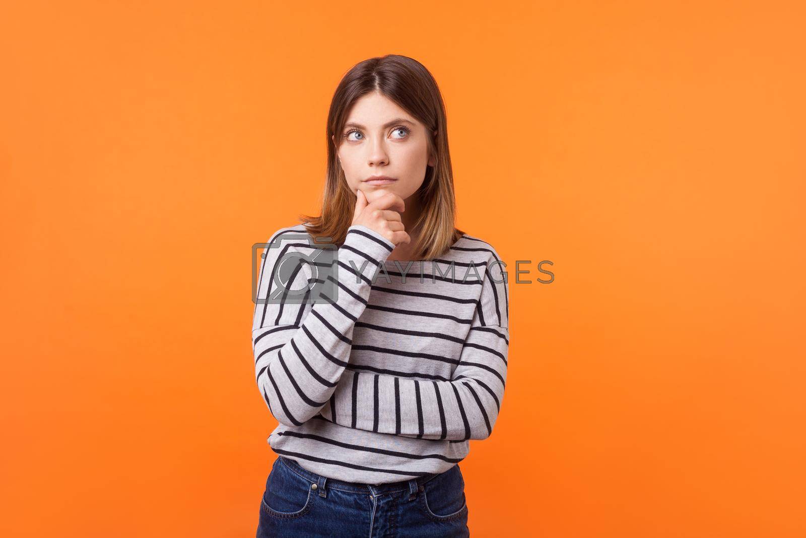 Royalty free image of Emotional young brunette woman on orange background. by Khosro1