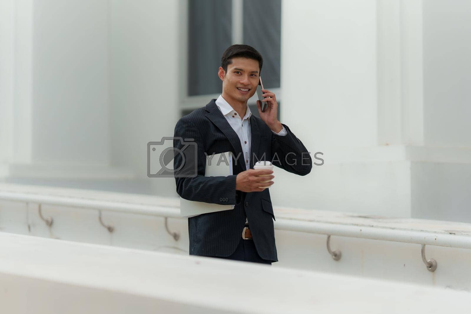 Royalty free image of Portrait of Asian Business man talking and dealing with customer by cell phone. Account and Finance concept. by itchaznong