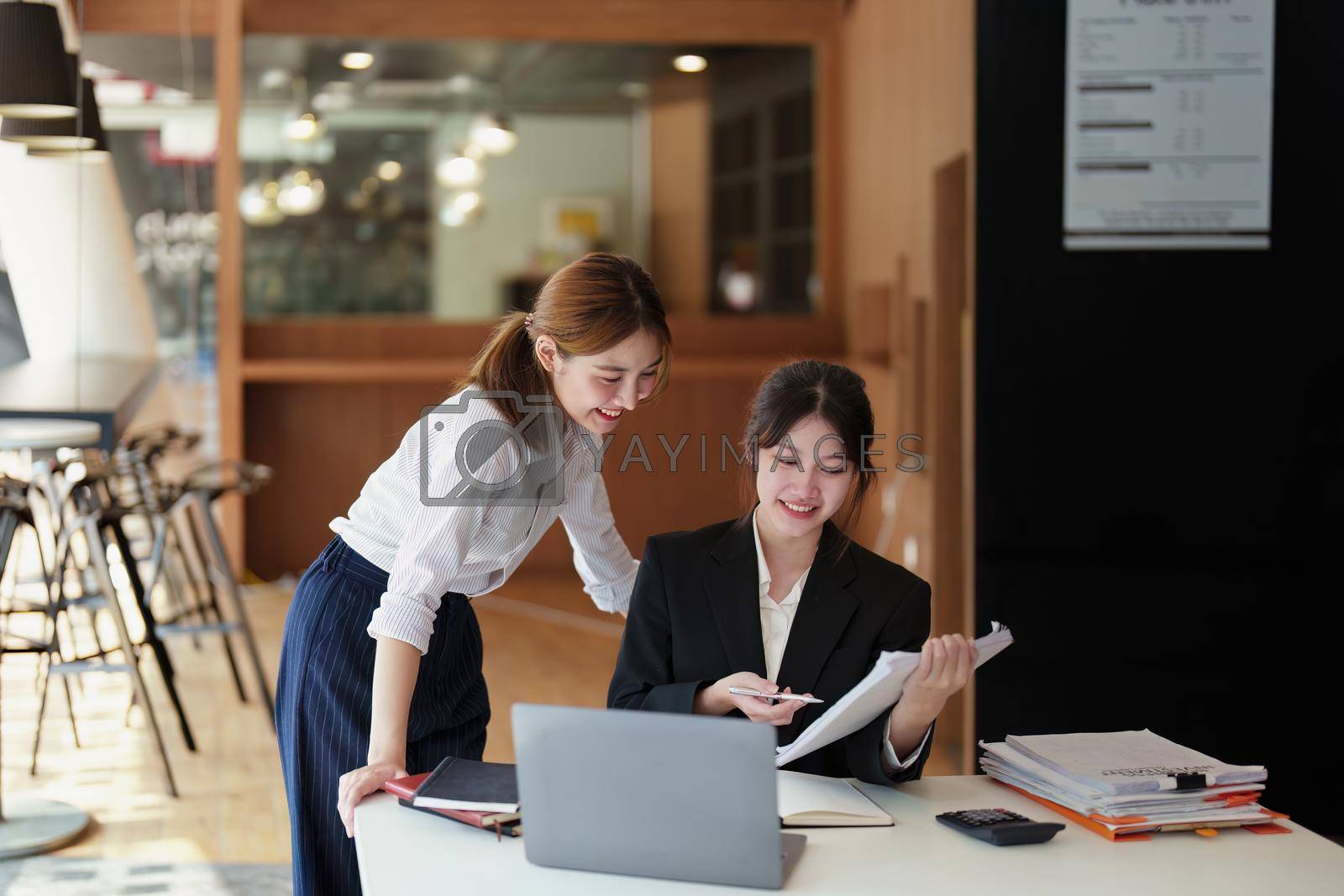 Royalty free image of A portrait of two young Asian businesswoman plan marketing strategies and investments to profit from their clients by Manastrong