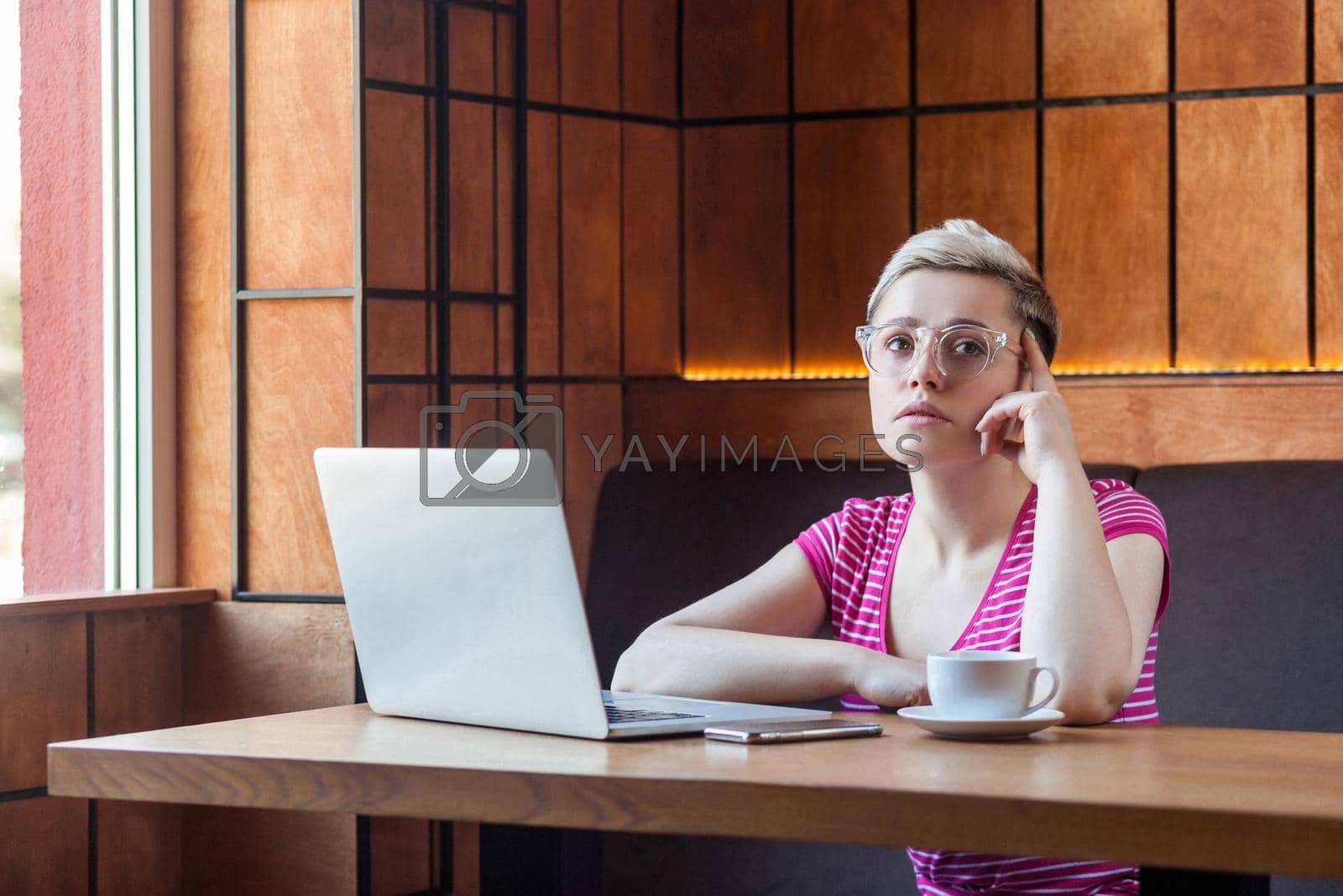 Royalty free image of Emotional young woman sitting and working in office by Khosro1