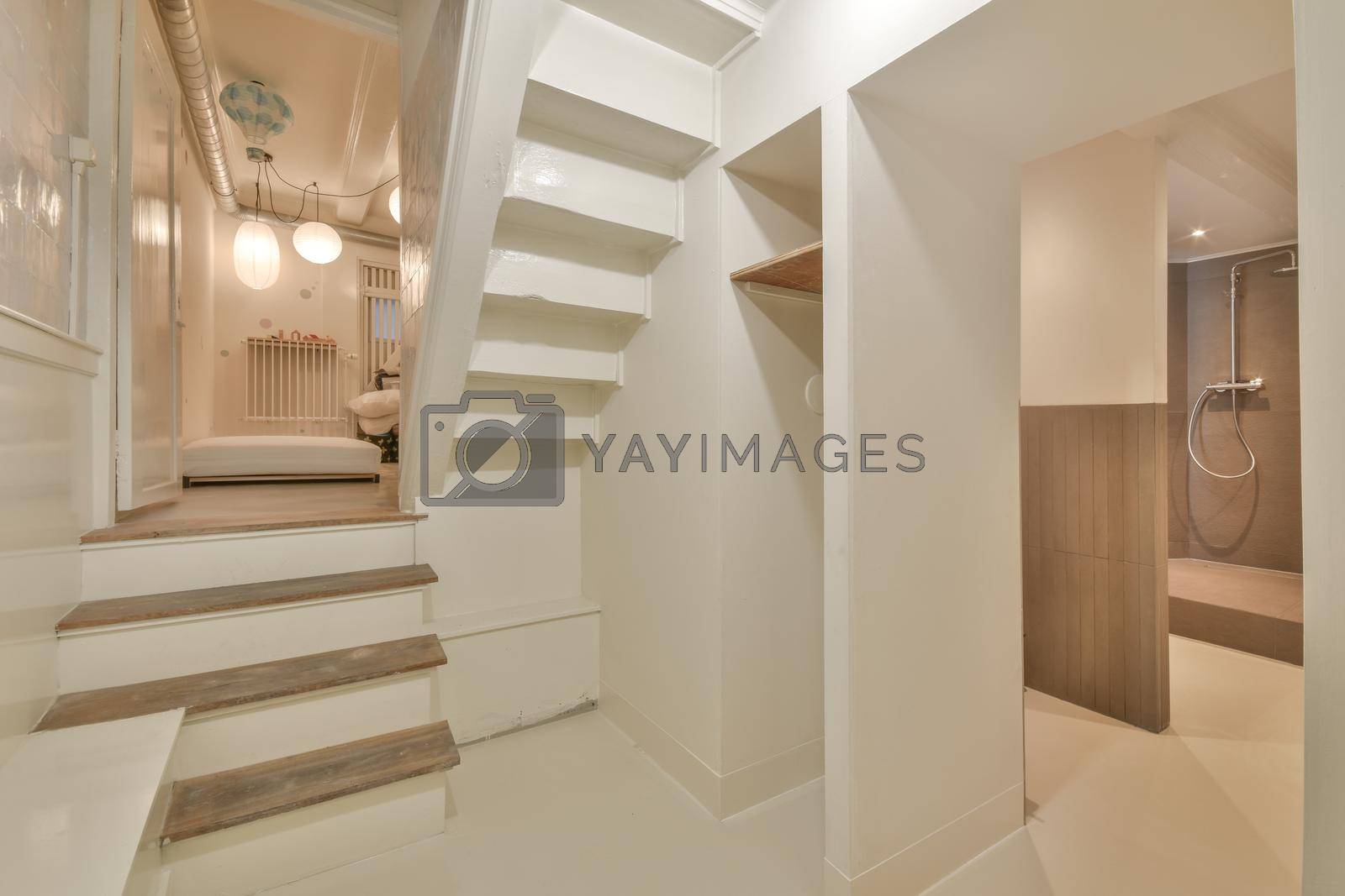 Royalty free image of Spacious bright corridor with stairs and entrance to the bedroom by casamedia