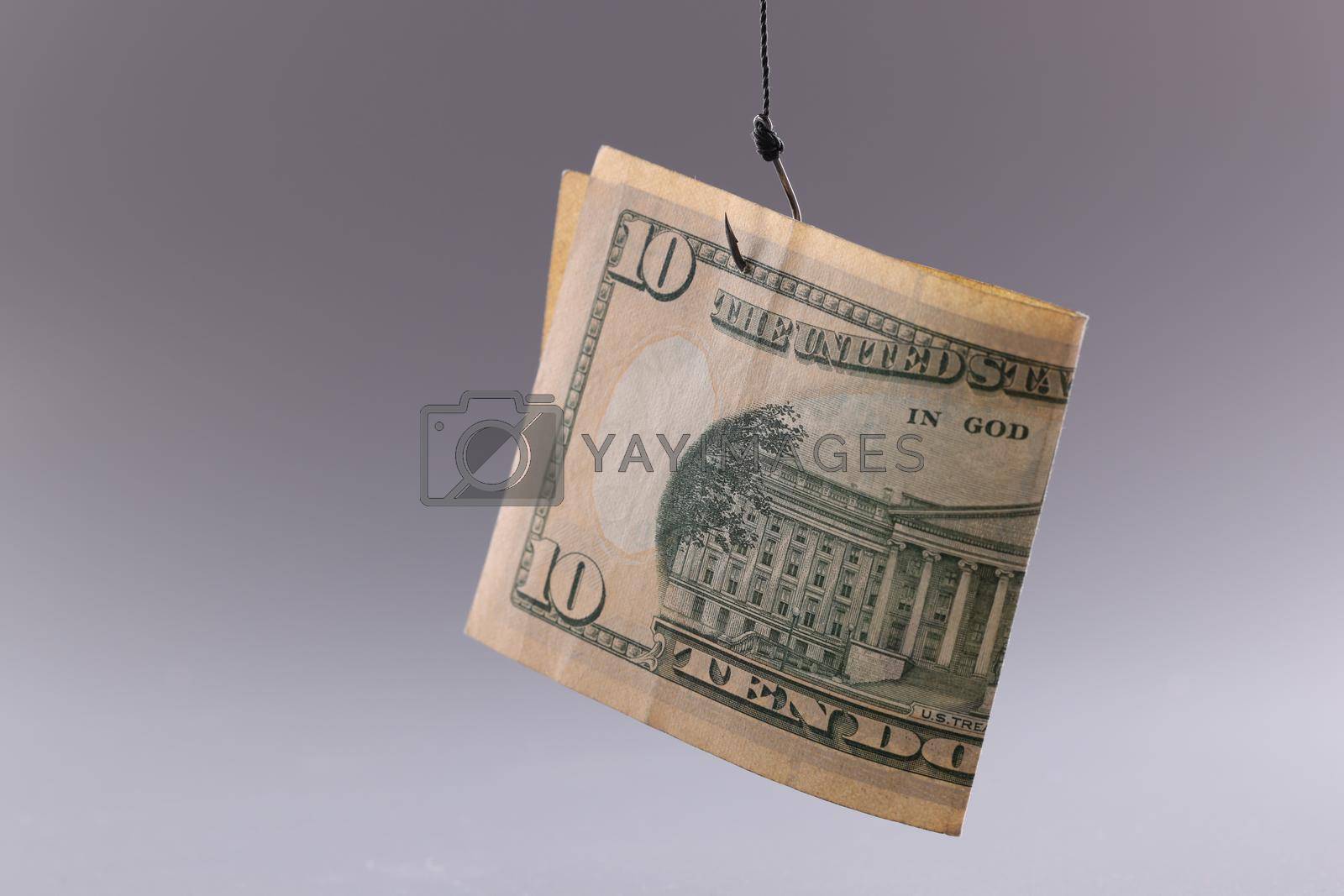 Royalty free image of Ten dollar bill on gray background. Arnings with minimal investment by kuprevich